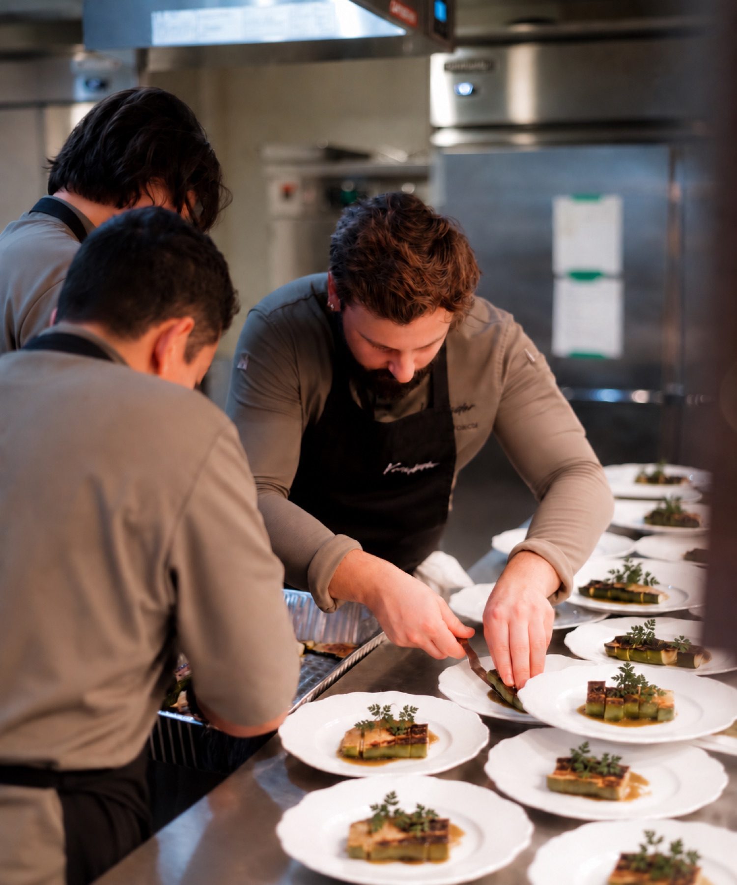Chef Francis plating a tasting menu course in a client kitchen