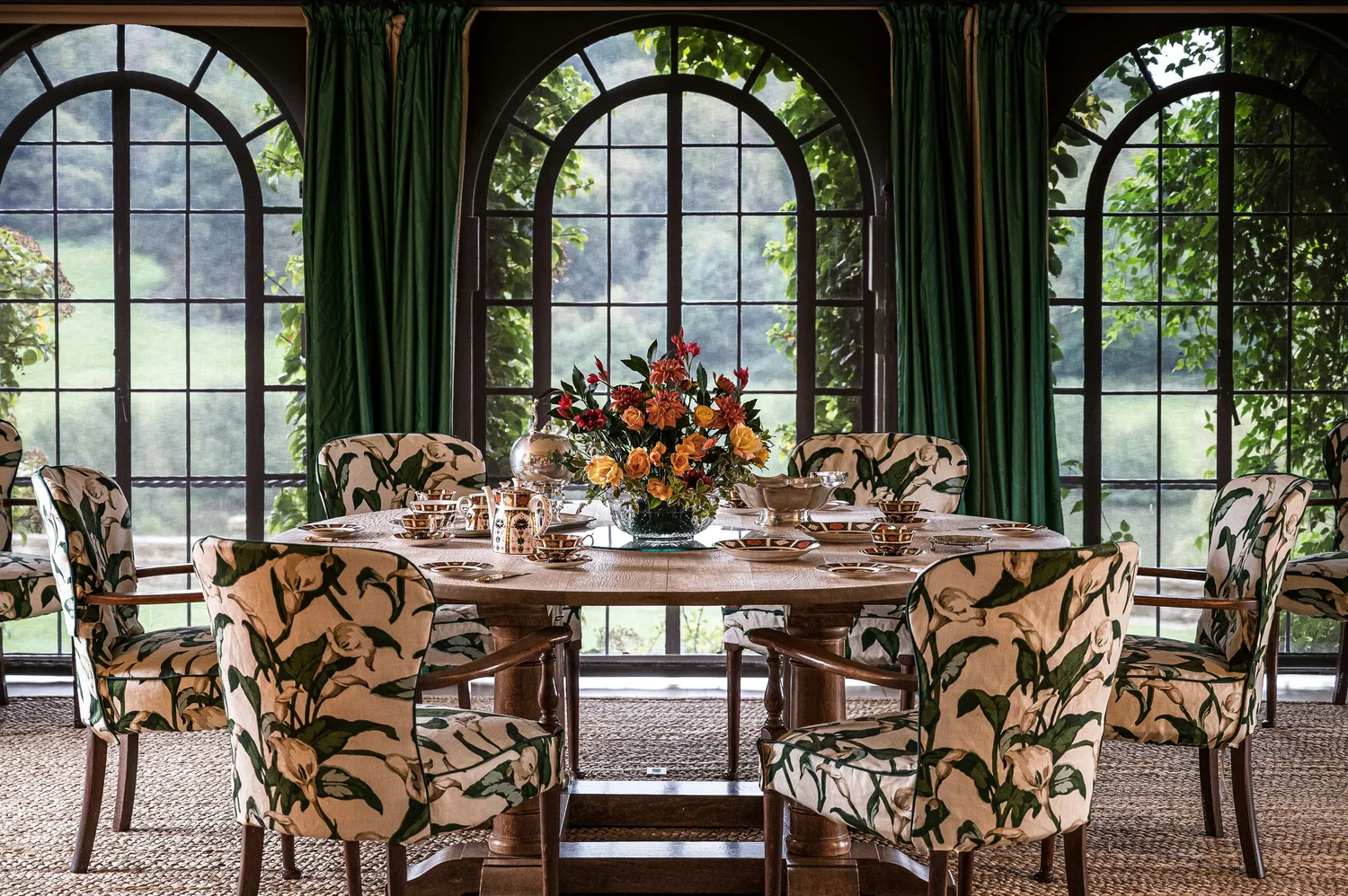 A garden dining room set for tea in a suburban estate