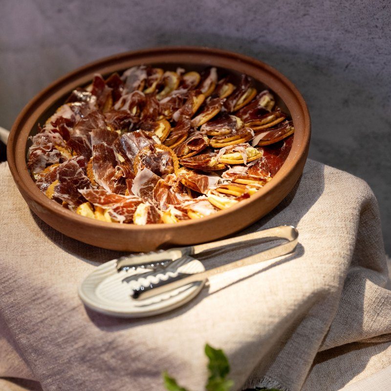 Jamón beurre in a terracotta bowl on linen