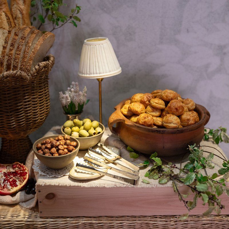 Gougère cheese puffs displayed with fruit and greenery