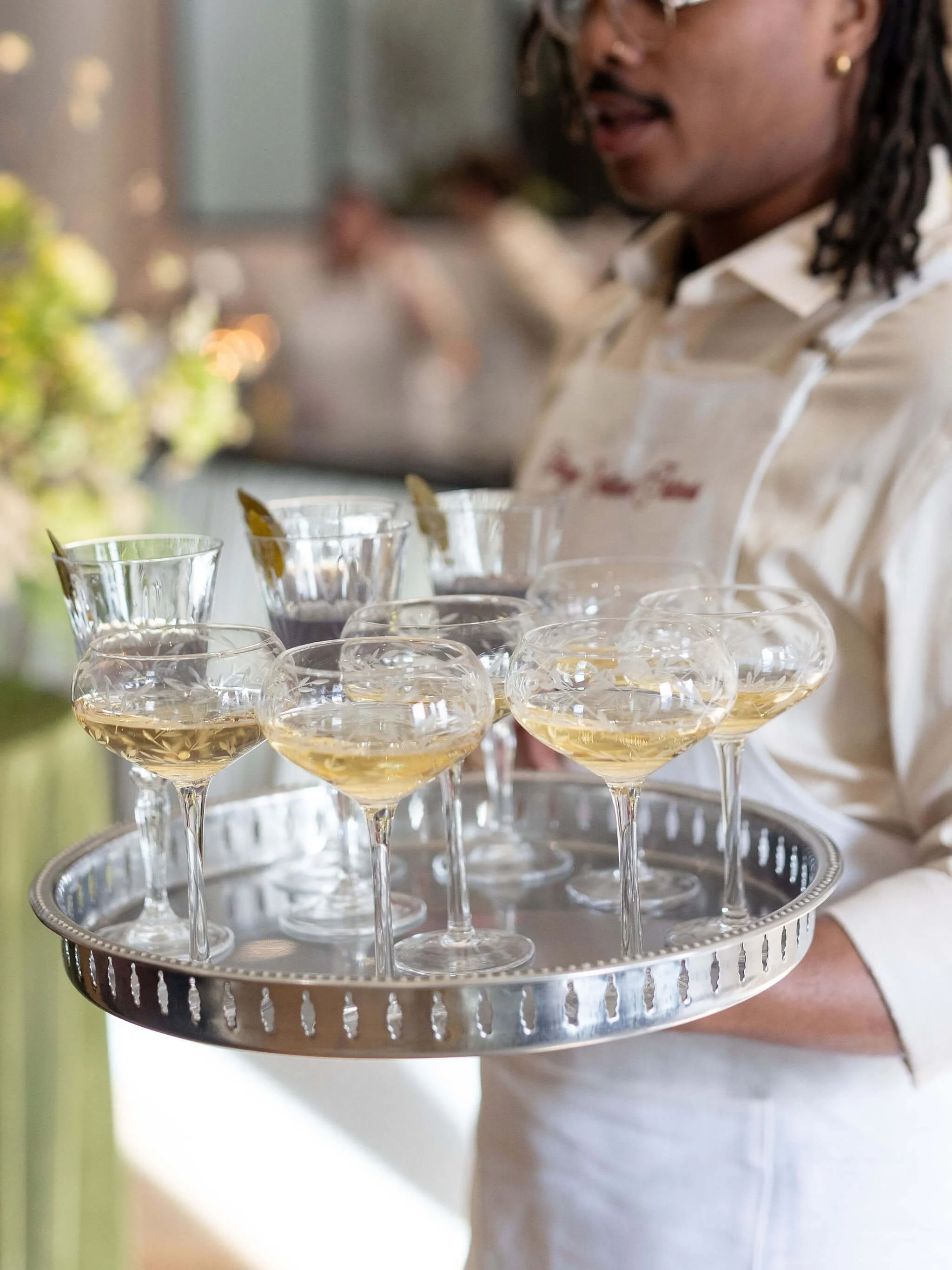 Champagne coupes and passed canap&eacute;s styled for a private retail event