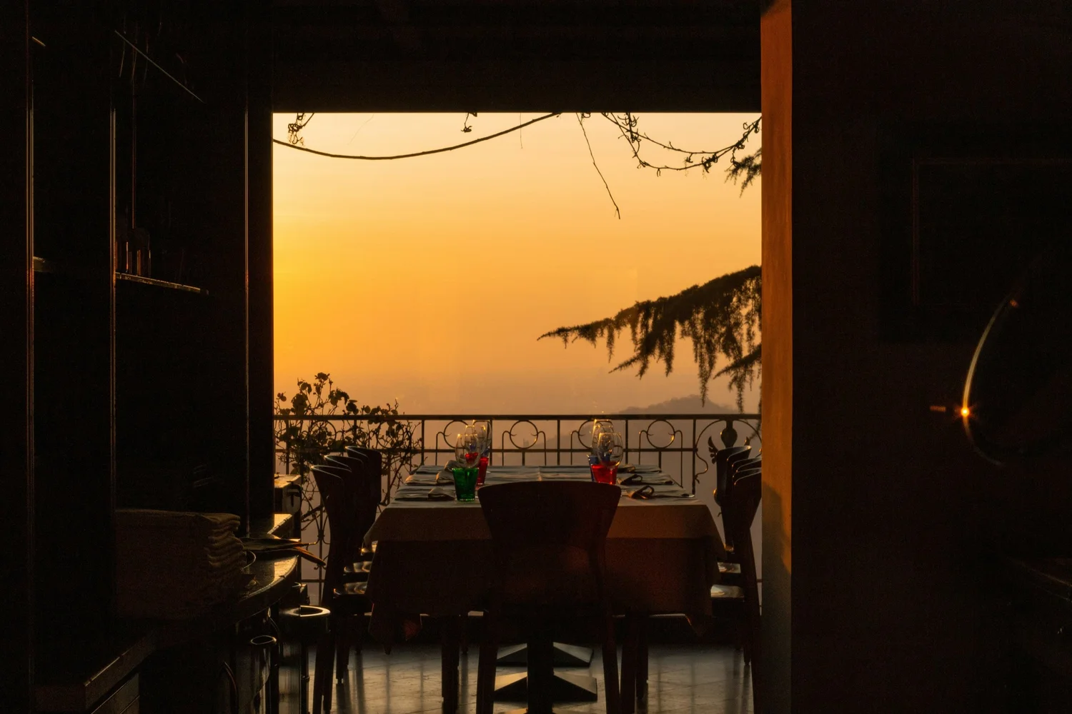 A table set before a golden sunset view