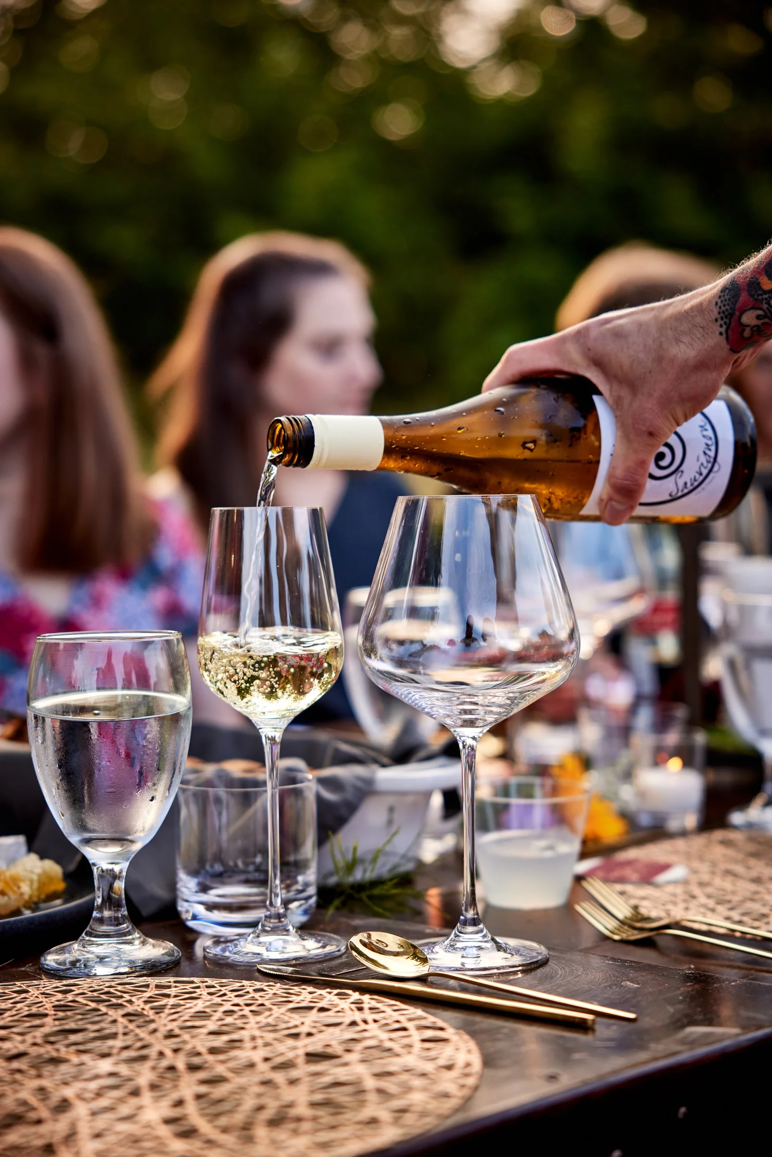 Wine poured at a getaway table on the water