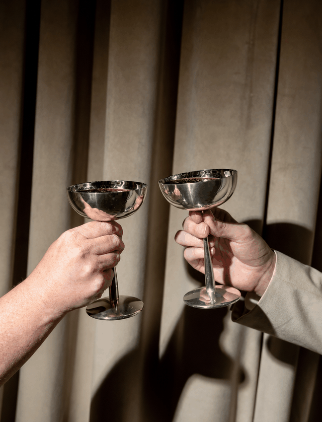 Silver coupes meeting in a toast