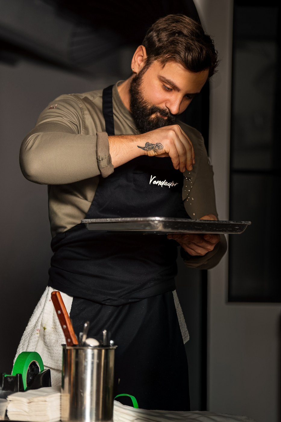 Chef Francis Pascal seasoning a dish in the Vendador kitchen